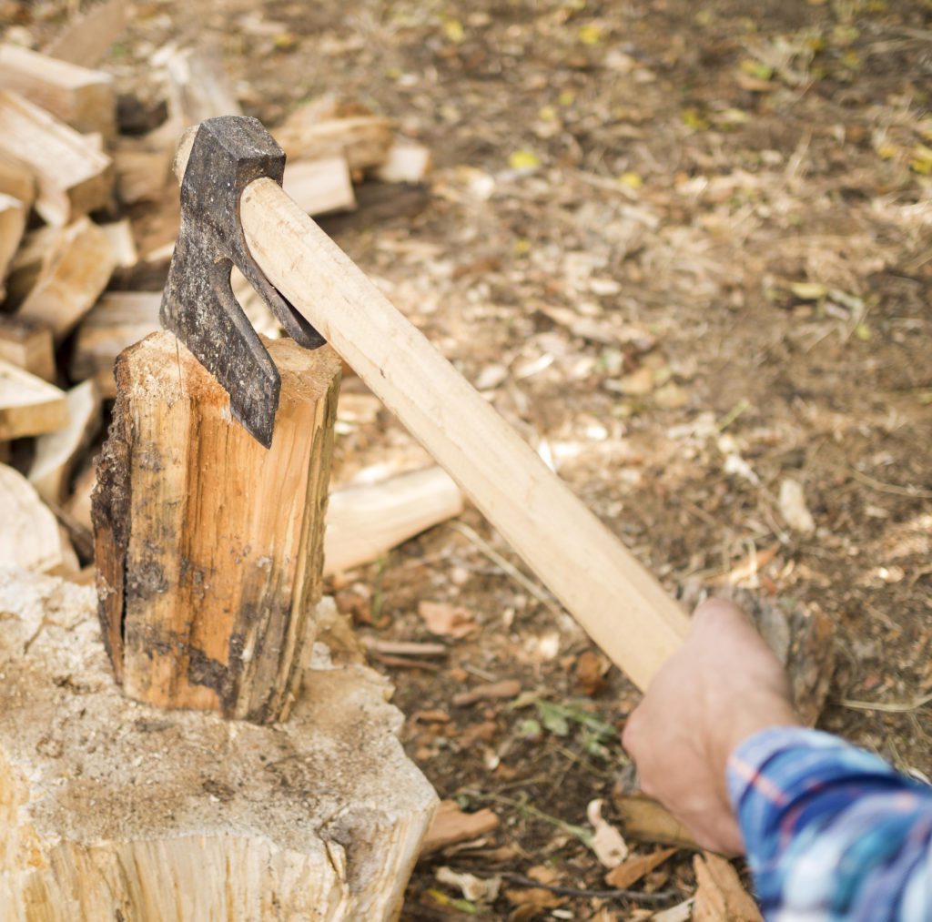 man-using-axe-chop-wood